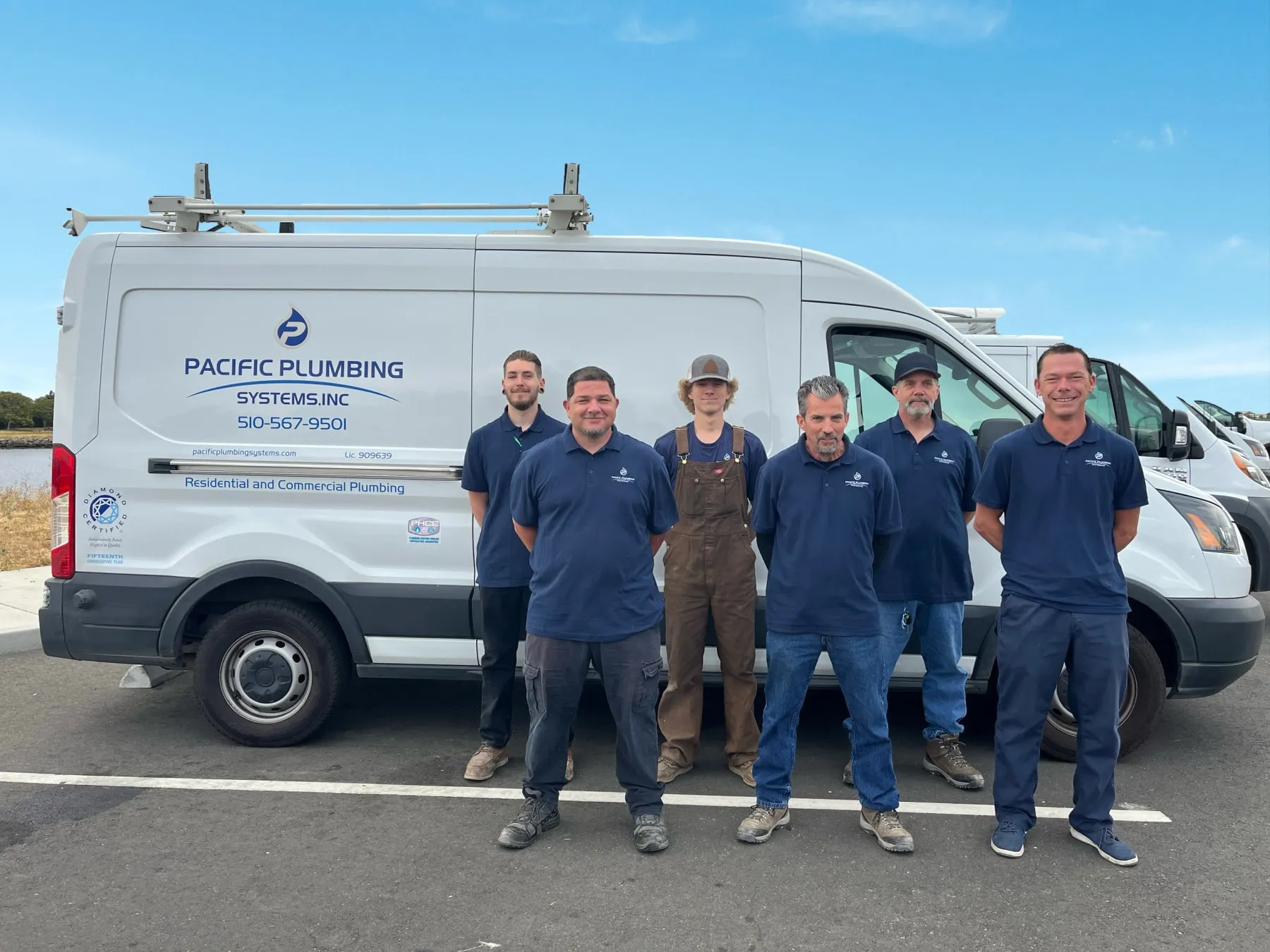 The six plumbers standing in front of a Pacific Plumbing Systems van